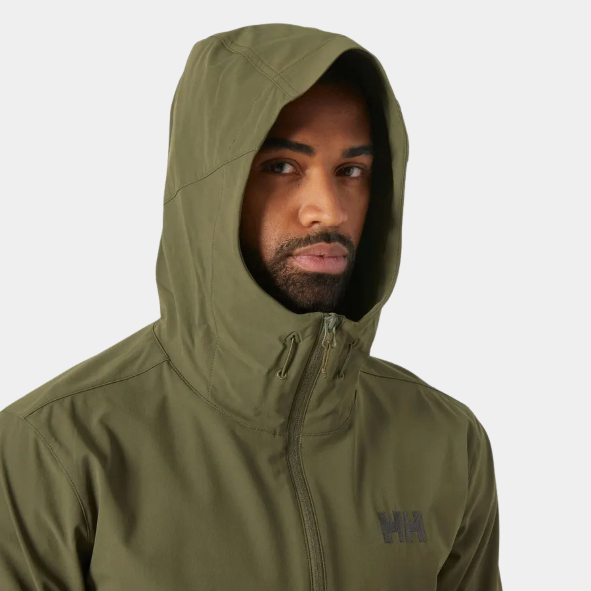 Man wearing the Utility Green Helly Hansen Blaze Softshell Hooded Jacket at U.S. Elite with the hood up