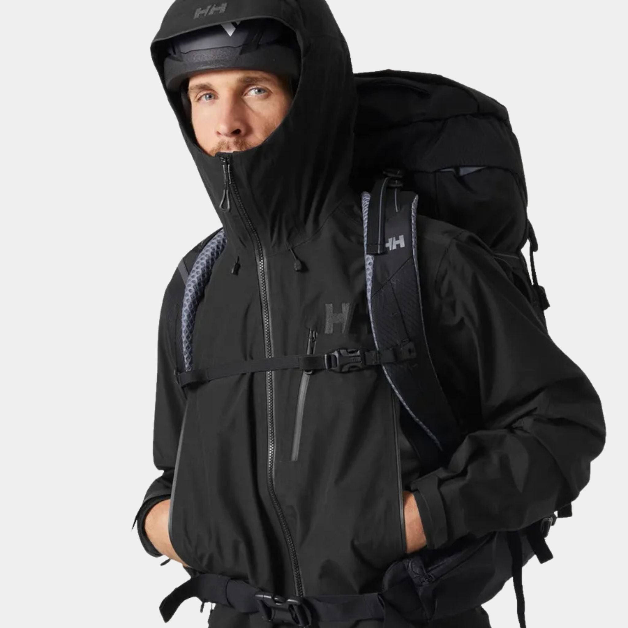 Helly Hansen Odin 9 Worlds 3.0 Hard Shell Jacket in Black being worn by a male model with a helmet and pack