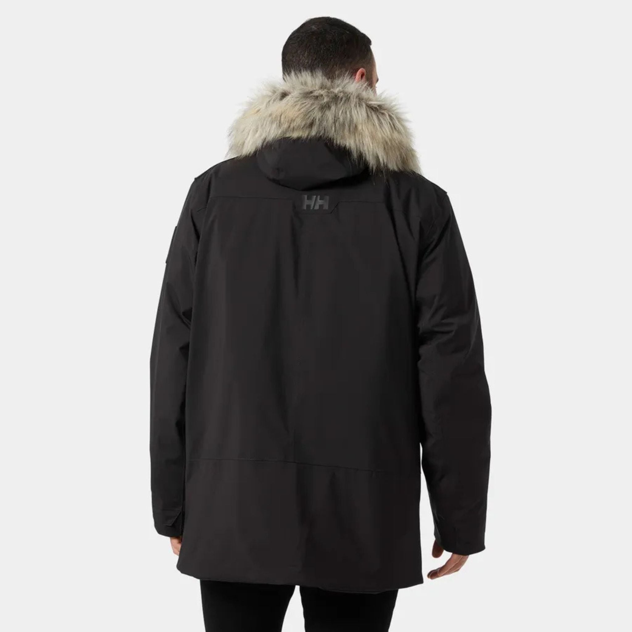 Back View of a Male Model Wearing the Helly Hansen Reine Parka in Black