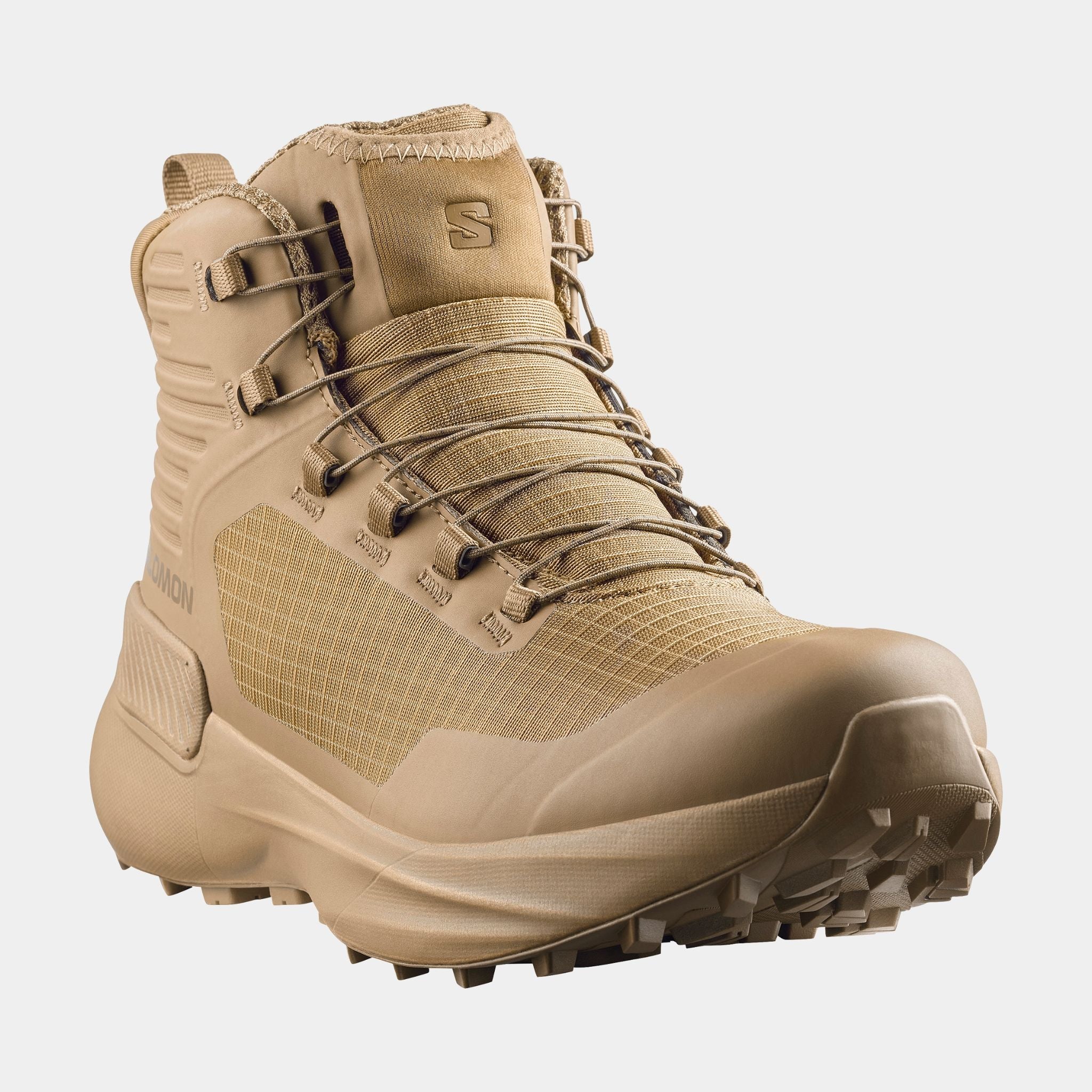 A Salomon Genesis boot in a uniform coyote tan color, shown from a three-quarters angle against a light gray background.