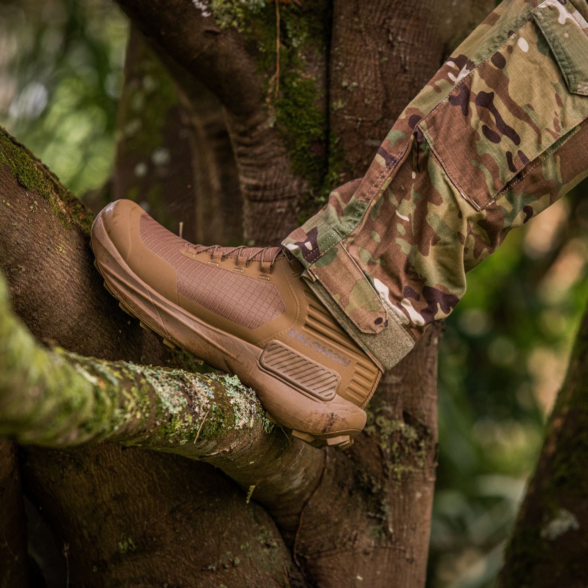 The Salomon Genesis Boot on a tree being worn by soldier