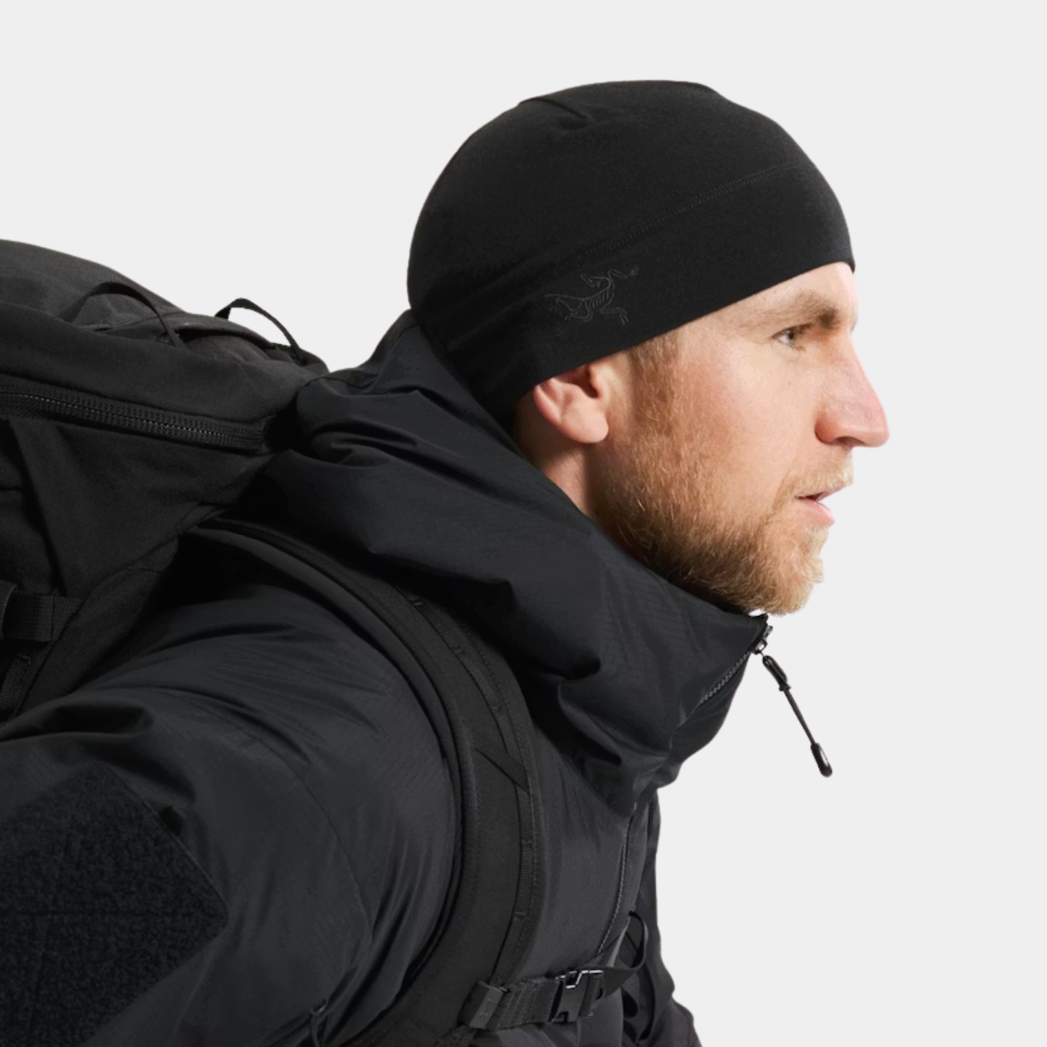 Side view of a tactical model wearing an Arc'teryx PRO Essentials Cold WX Beanie in Black at US Elite