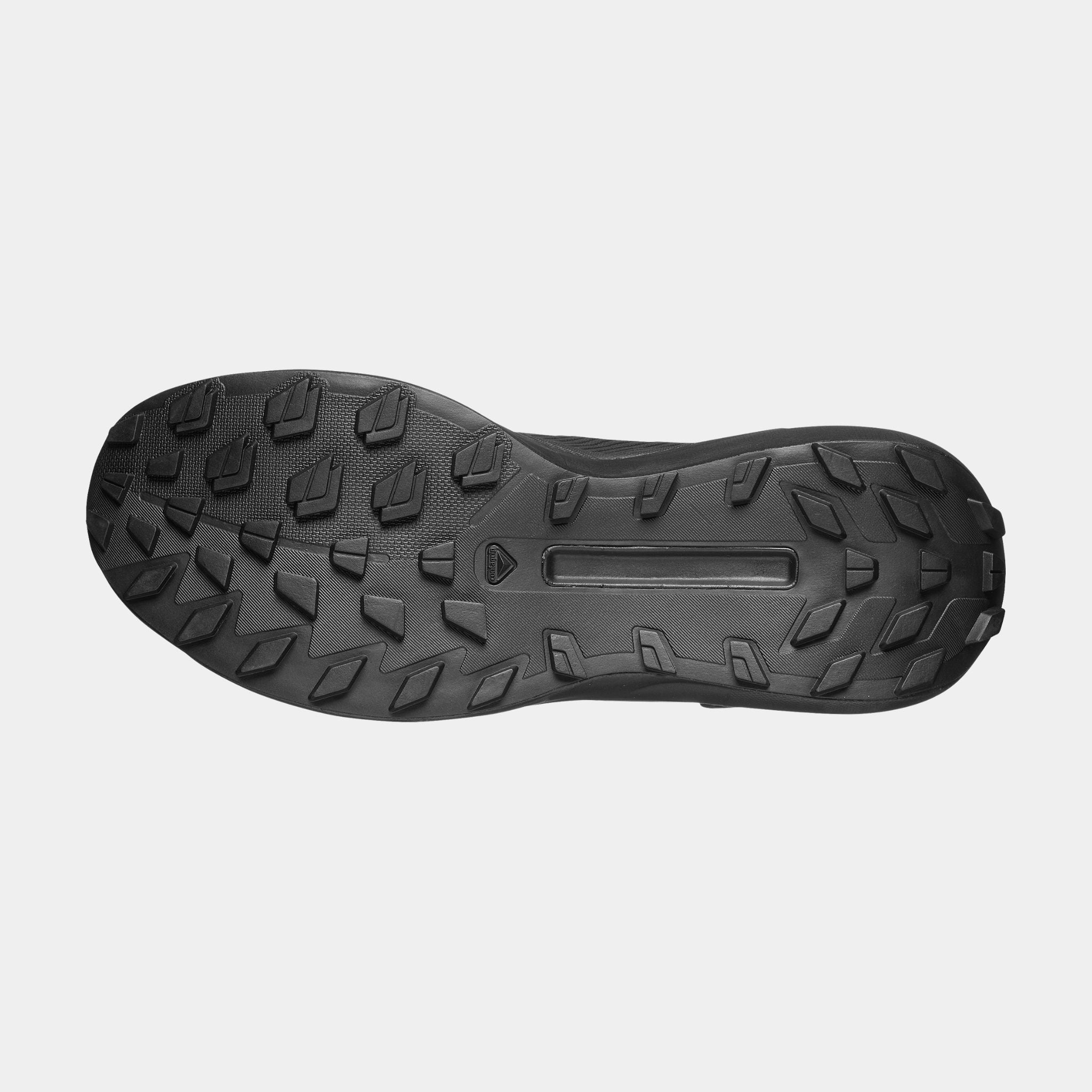 The outsole of a Salomon Genesis boot, showing its aggressive tread pattern, photographed from a top-down view against a light gray background.